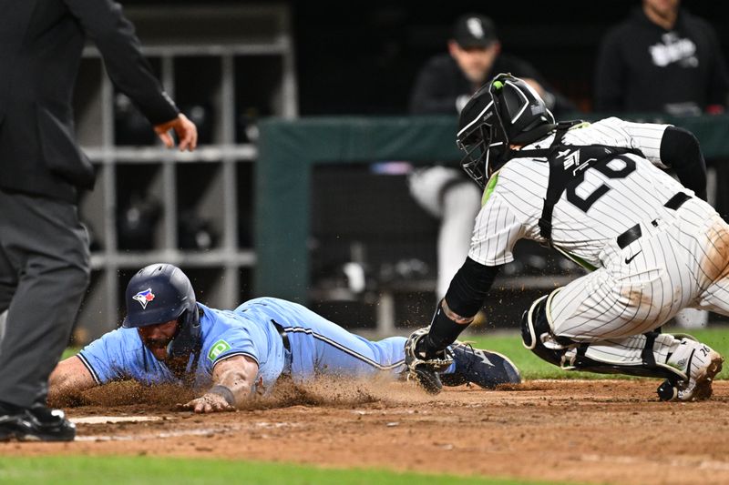 May 28, 2024; Chicago, Illinois, USA;  Toronto Blue Jays infielder Davis Schneider (36) scores a run past Chicago White Sox catcher Korey Lee (26) in the eighth inning at Guaranteed Rate Field. Mandatory Credit: Jamie Sabau-USA TODAY Sports