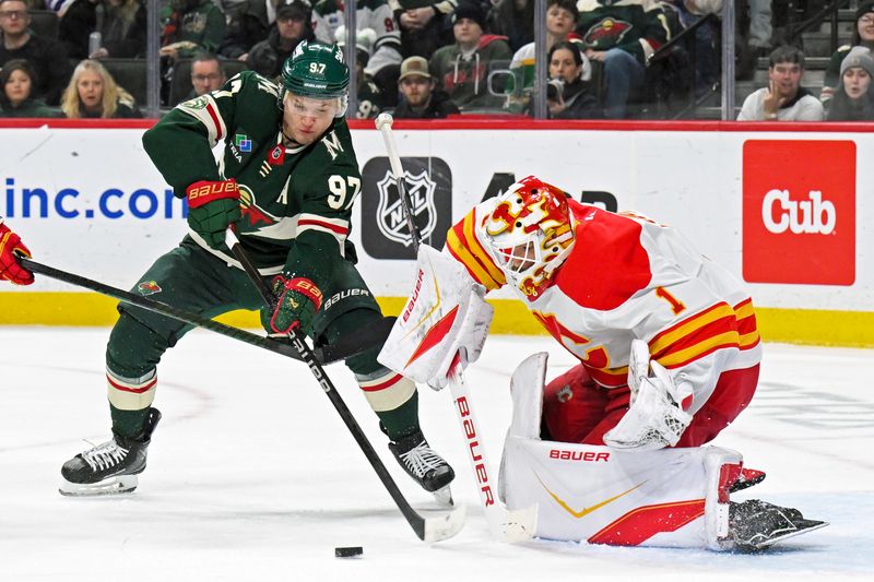 Jan 29, 2026; Saint Paul, Minnesota, USA;  Calgary Flames goalie Devin Cooley (1) makes a save on Minnesota Wild forward Kirill Kaprizov (97) during the second period at Grand Casino Arena. Mandatory Credit: Nick Wosika-Imagn Images