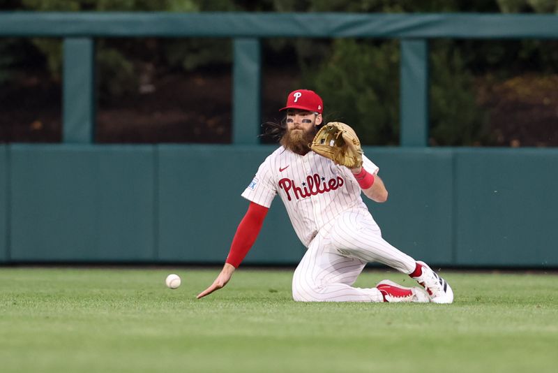 May 3, 2025; Philadelphia, Pennsylvania, USA; Philadelphia Phillies Brandon Marsh attempts to field the single of third base Eugenio Suárez (not pictured) during the fourth inning at Citizens Bank Park. Mandatory Credit: Bill Streicher-Imagn Images