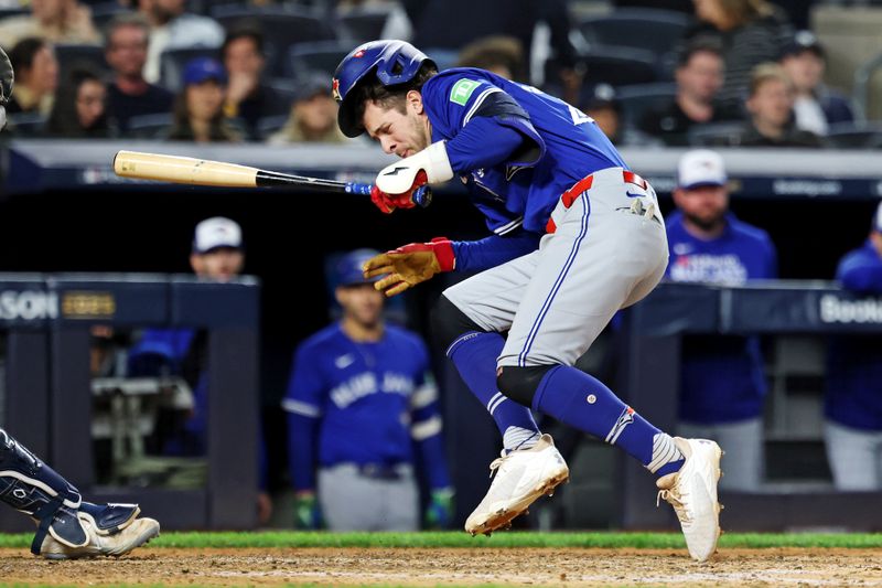 Oct 8, 2025; Bronx, New York, USA; Toronto Blue Jays third baseman Ernie Clement (22) is hit by a pitch during the eighth inning against the New York Yankees during game four of the ALDS round for the 2025 MLB playoffs at Yankee Stadium. Mandatory Credit: Vincent Carchietta-Imagn Images