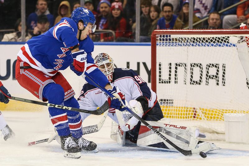 Nov 12, 2023; New York, New York, USA; Columbus Blue Jackets goaltender Elvis Merzlikins (90) makes a save on a shot on goal attempt by New York Rangers left wing Will Cuylle (50) in the third period at Madison Square Garden. Mandatory Credit: Wendell Cruz-USA TODAY Sports