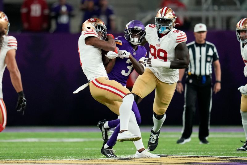 San Francisco 49ers cornerback Charvarius Ward, left, intercepts a pass intended for Minnesota Vikings wide receiver Jordan Addison (3) during the first half of an NFL football game, Monday, Oct. 23, 2023, in Minneapolis. (AP Photo/Abbie Parr)