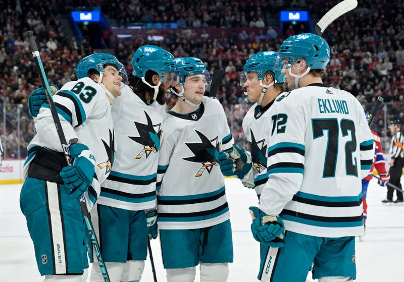 Jan 11, 2024; Montreal, Quebec, CAN; San Jose Sharks defenseman Nikita Okhotiuk (83) celebrates with teammates including defenseman Calen Addison (33) and forward Anthony Duclair (10) after scoring a goal against the Montreal Canadiens during the second period at the Bell Centre. Mandatory Credit: Eric Bolte-USA TODAY Sports