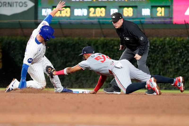 Aug 6, 2024; Chicago, Illinois, USA; Chicago Cubs first baseman Michael Busch (29) is safe at second base as Minnesota Twins shortstop Willi Castro (50) makes a late tag during the fifth inning at Wrigley Field. Mandatory Credit: David Banks-USA TODAY Sports