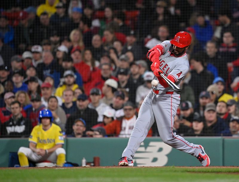 Apr 12, 2024; Boston, Massachusetts, USA; Los Angeles Angels right fielder Aaron Hicks (12) hits a single during the third inning against the Boston Red Sox at Fenway Park. Mandatory Credit: Eric Canha-USA TODAY Sports