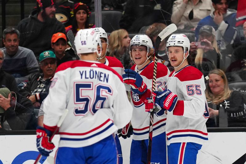 Nov 22, 2023; Anaheim, California, USA; Montreal Canadiens defenseman Kaiden Guhle (21) and left wing Michael Pezzetta (55) celebrate after a goal against the Anaheim Ducks in the first period at Honda Center. Mandatory Credit: Kirby Lee-USA TODAY Sports