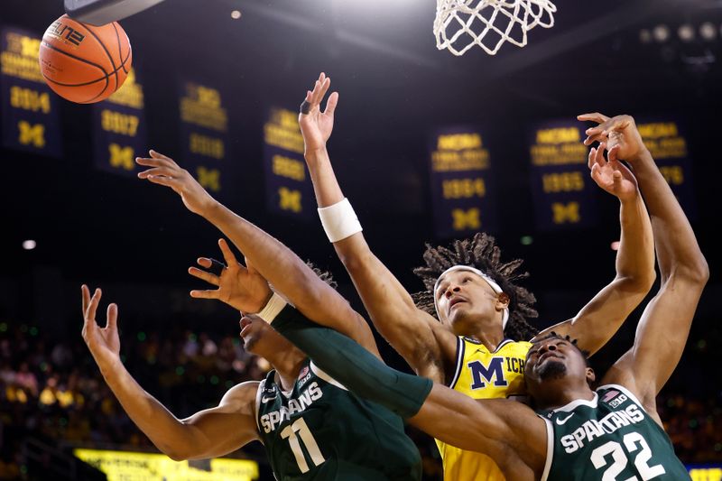 Feb 18, 2023; Ann Arbor, Michigan, USA;  Michigan State Spartans guard A.J. Hoggard (11) and Michigan Wolverines guard Kobe Bufkin (2) and center Mady Sissoko (22) battle for a rebound in the first half at Crisler Center. Mandatory Credit: Rick Osentoski-USA TODAY Sports