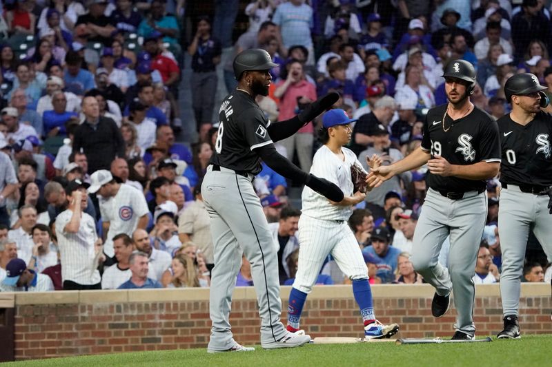 Jun 4, 2024; Chicago, Illinois, USA; Chicago White Sox shortstop Paul DeJong (29) is greeted by Luis Robert during the fourth inning at Wrigley Field. Mandatory Credit: David Banks-USA TODAY Sports