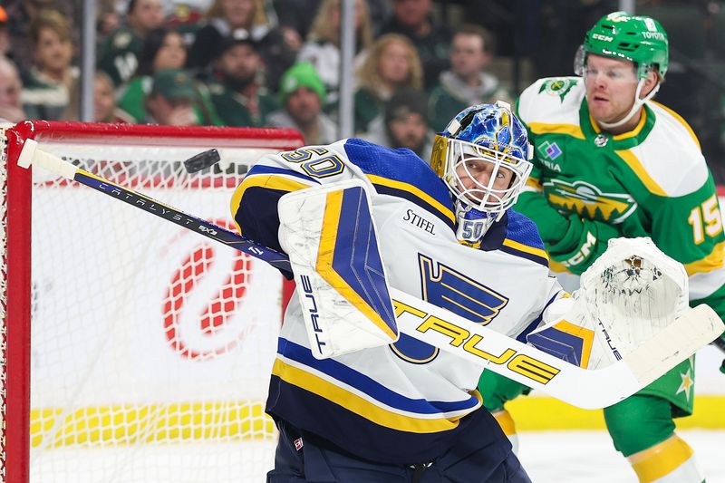 Mar 23, 2024; Saint Paul, Minnesota, USA; St. Louis Blues goaltender Jordan Binnington (50) makes a save against the Minnesota Wild during the first period at Xcel Energy Center. Mandatory Credit: Matt Krohn-USA TODAY Sports