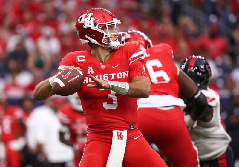 Sep 4, 2021; Houston, Texas, USA; Houston Cougars quarterback Clayton Tune (3) drops back to pass against the Texas Tech Red Raiders during the first quarter at NRG Stadium. Mandatory Credit: Troy Taormina-USA TODAY Sports