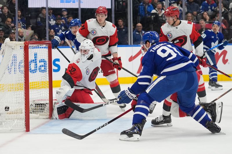 Nov 9, 2025; Toronto, Ontario, CAN; Toronto Maple Leafs forward John Tavares (91) scores against Carolina Hurricanes goaltender Brandon Bussi (32) during the first period at Scotiabank Arena. Mandatory Credit: John E. Sokolowski-Imagn Images