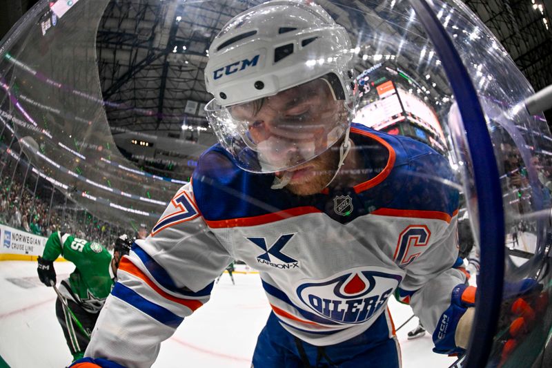 May 21, 2025; Dallas, Texas, USA; Edmonton Oilers center Connor McDavid (97) battles for control of the puck during the game between the Dallas Stars and the Oilers in game one of the Western Conference Final of the 2025 Stanley Cup Playoffs at American Airlines Center. Mandatory Credit: Jerome Miron-Imagn Images