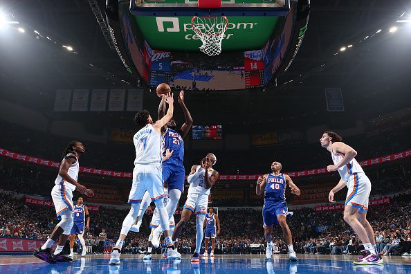 OKLAHOMA CITY, OK - NOVEMBER 25:  Joel Embiid #21 of the Philadelphia 76ers drives to the basket during the game as Chet Holmgren #7 of the Oklahoma City Thunder plays defense on November 25, 2023 at Paycom Arena in Oklahoma City, Oklahoma. NOTE TO USER: User expressly acknowledges and agrees that, by downloading and or using this photograph, User is consenting to the terms and conditions of the Getty Images License Agreement. Mandatory Copyright Notice: Copyright 2023 NBAE (Photo by Zach Beeker/NBAE via Getty Images)