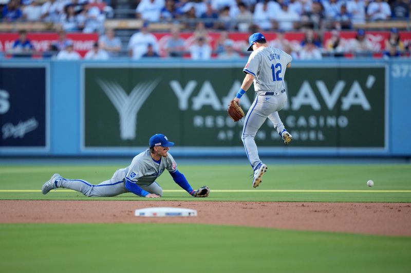 Jun 15, 2024; Los Angeles, California, USA; Kansas City Royals shortstop Bobby Witt Jr. (7) and second baseman Nick Loftin (12) attempt to field the ball against the Los Angeles Dodgers at Dodger Stadium. Mandatory Credit: Kirby Lee-USA TODAY Sports