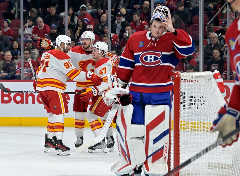 Nov 14, 2023; Montreal, Quebec, CAN; Calgary Flames forward Connor Zary (47) celebrates with teammates after scoring a goal against Montreal Canadiens goalie Sam Montembeault (35) during the second period at the Bell Centre. Mandatory Credit: Eric Bolte-USA TODAY Sports