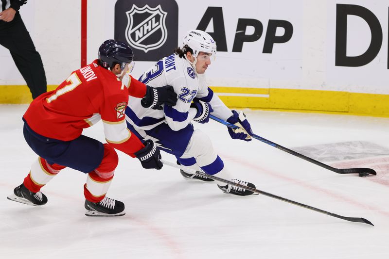 Apr 21, 2024; Sunrise, Florida, USA; Tampa Bay Lightning center Michael Eyssimont (23) moves the puck past Florida Panthers defenseman Dmitry Kulikov (7) during the third period in game one of the first round of the 2024 Stanley Cup Playoffs at Amerant Bank Arena. Mandatory Credit: Sam Navarro-USA TODAY Sports