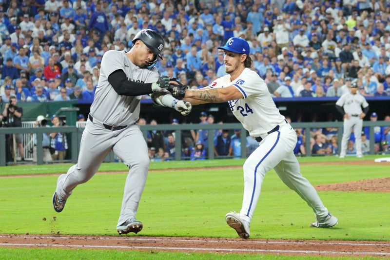 Oct 9, 2024; Kansas City, Missouri, USA; Kansas City Royals major league field coordinator, third base coach Vance Wilson (25) tags out New York Yankees second base Gleyber Torres (25) in the ninth inning during game three of the NLDS for the 2024 MLB Playoffs at Kauffman Stadium. Mandatory Credit: Jay Biggerstaff-Imagn Images