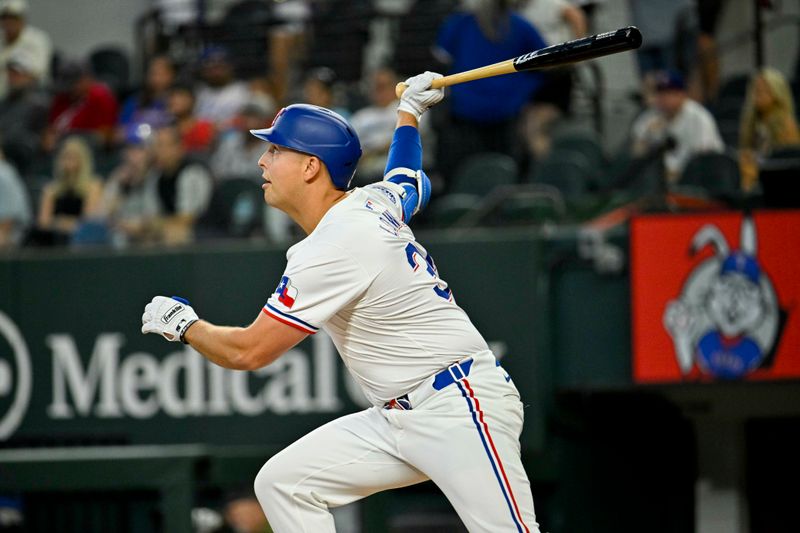 Jun 8, 2024; Arlington, Texas, USA; Texas Rangers first baseman Nathaniel Lowe (30) drives in a run against the San Francisco Giants during the first inning at Globe Life Field. Mandatory Credit: Jerome Miron-USA TODAY Sports