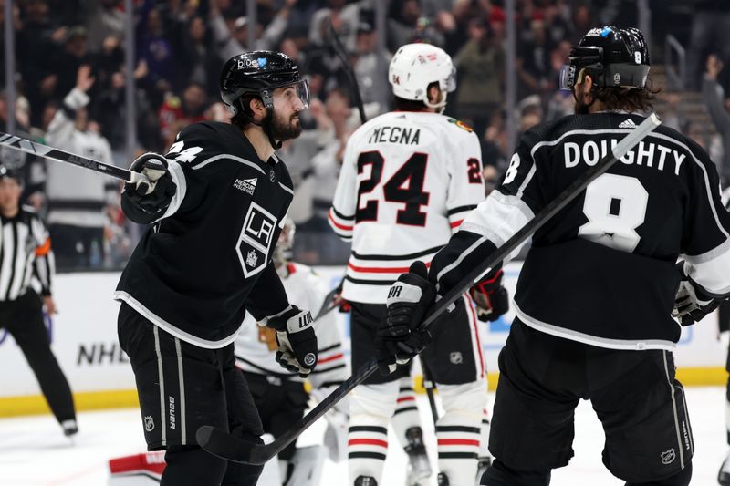 Mar 19, 2024; Los Angeles, California, USA;  Los Angeles Kings center Phillip Danault (24) celebrates with defenseman Drew Doughty (8) after scoring a goal during the third period against the Chicago Blackhawks at Crypto.com Arena. Mandatory Credit: Kiyoshi Mio-USA TODAY Sports