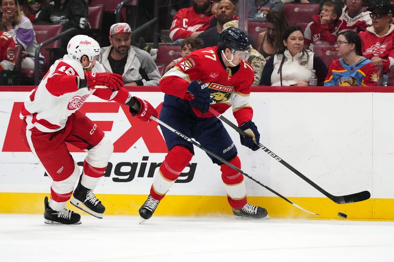 Jan 17, 2024; Sunrise, Florida, USA; Detroit Red Wings defenseman Jeff Petry (46) battles Florida Panthers defenseman Niko Mikkola (77) for the puck during the second period at Amerant Bank Arena. Mandatory Credit: Jasen Vinlove-USA TODAY Sports