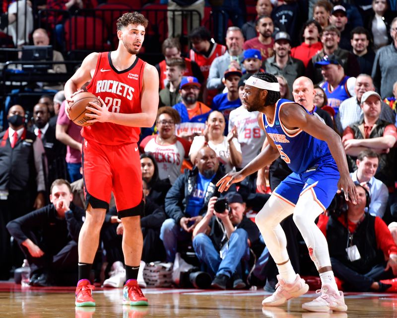 HOUSTON, TX - FEBRUARY 12: Alperen Sengun #28 of the Houston Rockets looks to pass the ball during the game against the New York Knicks on February 12, 2024 at the Toyota Center in Houston, Texas. NOTE TO USER: User expressly acknowledges and agrees that, by downloading and or using this photograph, User is consenting to the terms and conditions of the Getty Images License Agreement. Mandatory Copyright Notice: Copyright 2024 NBAE (Photo by Logan Riely/NBAE via Getty Images)