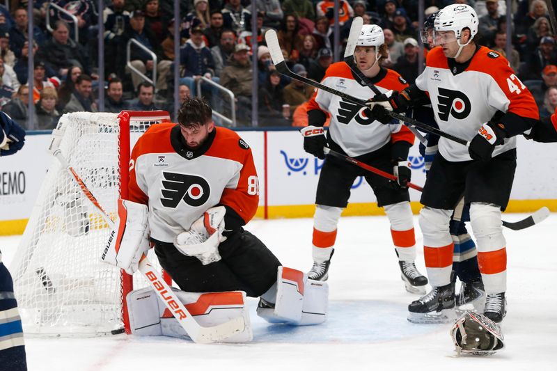 Jan 28, 2026; Columbus, Ohio, USA; Philadelphia Flyers goalie Dan Vladar (80) makes a save after losing his mask against the Columbus Blue Jackets during the second period at Nationwide Arena. Mandatory Credit: Russell LaBounty-Imagn Images