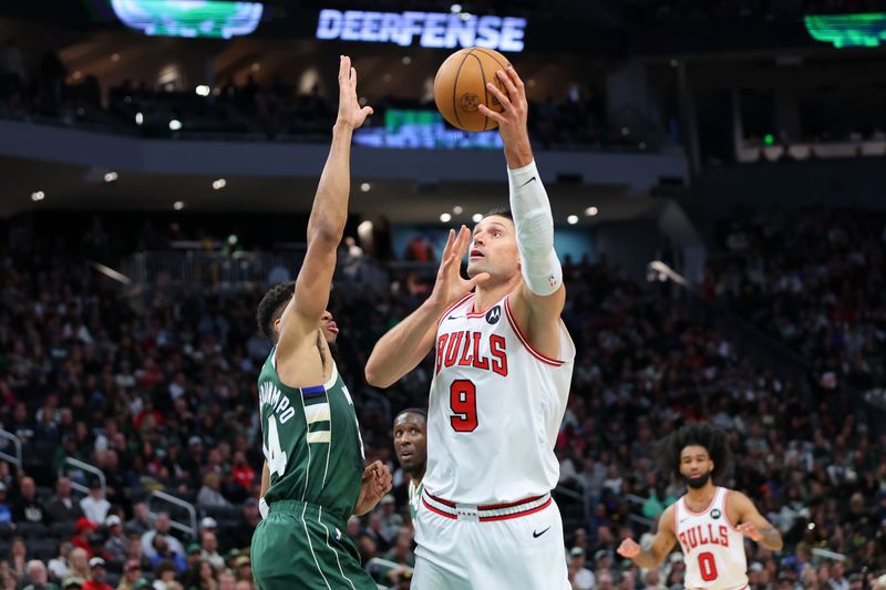 MILWAUKEE, WISCONSIN - OCTOBER 25: Nikola Vucevic #9 of the Chicago Bulls is defended by Giannis Antetokounmpo #34 of the Milwaukee Bucks during the first half of a game at Fiserv Forum on October 25, 2024 in Milwaukee, Wisconsin. NOTE TO USER: User expressly acknowledges and agrees that, by downloading and or using this photograph, User is consenting to the terms and conditions of the Getty Images License Agreement. (Photo by Stacy Revere/Getty Images)