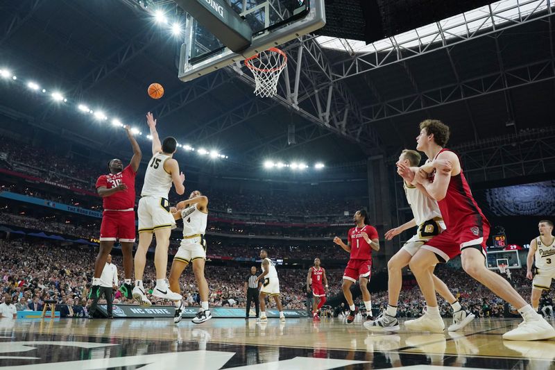 Apr 6, 2024; Glendale, AZ, USA;  North Carolina State Wolfpack forward DJ Burns Jr. (30) shoots over Purdue Boilermakers center Zach Edey (15) in the semifinals of the men's Final Four of the 2024 NCAA Tournament at State Farm Stadium. Mandatory Credit: Robert Deutsch-USA TODAY Sports