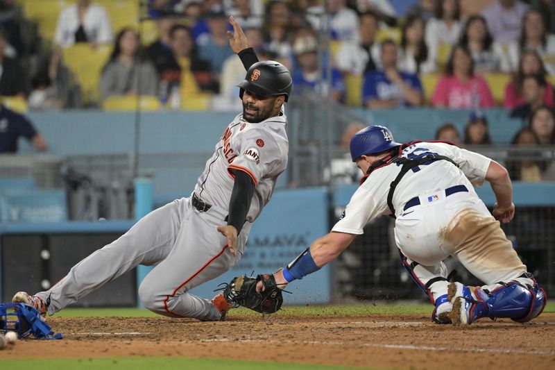 Jul 24, 2024; Los Angeles, California, USA;  Los Angeles Dodgers catcher Will Smith (16) misses the tag on San Francisco Giants first baseman LaMonte Wade Jr. (31) as he scores a run in the eighth inning at Dodger Stadium. Mandatory Credit: Jayne Kamin-Oncea-USA TODAY Sports