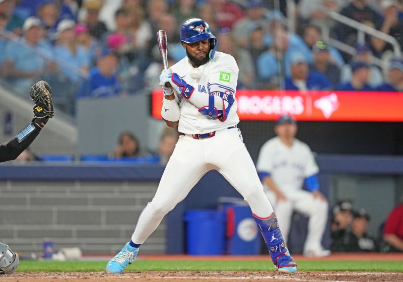 Jun 30, 2024; Toronto, Ontario, CAN; Toronto Blue Jays first base Vladimir Guerrero Jr. (27) gets hit with a pitch against the New York Yankees during the third inning at Rogers Centre. Mandatory Credit: Nick Turchiaro-USA TODAY Sports