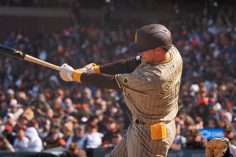 Apr 5, 2024; San Francisco, California, USA; San Diego Padres first baseman Jake Cronenworth (9) hits a single against the San Francisco Giants during the ninth inning at Oracle Park. Mandatory Credit: Kelley L Cox-USA TODAY Sports