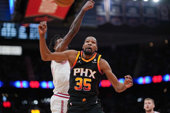 HOUSTON, TEXAS - DECEMBER 27: Kevin Durant #35 of the Phoenix Suns falls after a foul during the forth quarter of the game against the Houston Rockets at Toyota Center on December 27, 2023 in Houston, Texas. User expressly acknowledges and agrees that, by downloading and or using this photograph, User is consenting to the terms and conditions of the Getty Images License Agreement. (Photo by Alex Bierens de Haan/Getty Images)