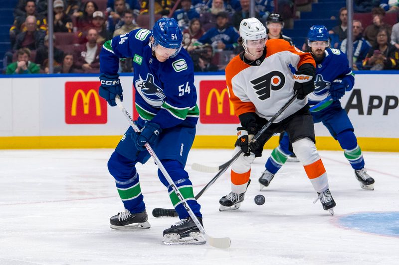 Oct 11, 2024; Vancouver, British Columbia, CAN; Philadelphia Flyers defenseman Jamie Drysdale (9) watches as Vancouver Canucks forward Aatu Raty (54) shoots during the first period at Rogers Arena. Mandatory Credit: Bob Frid-Imagn Images