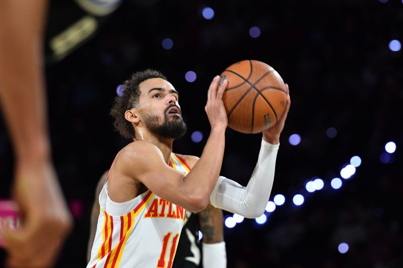 LAS VEGAS, NV - DECEMBER 14: Trae Young #11 of the Atlanta Hawks shoots a free throw during the game against the Milwaukee Bucks during the Emirates NBA Cup Semifinal game on December 14, 2024 at T-Mobile Arena in Las Vegas, Nevada. NOTE TO USER: User expressly acknowledges and agrees that, by downloading and/or using this Photograph, user is consenting to the terms and conditions of the Getty Images License Agreement. Mandatory Copyright Notice: Copyright 2024 NBAE (Photo by Juan Ocampo/NBAE via Getty Images)