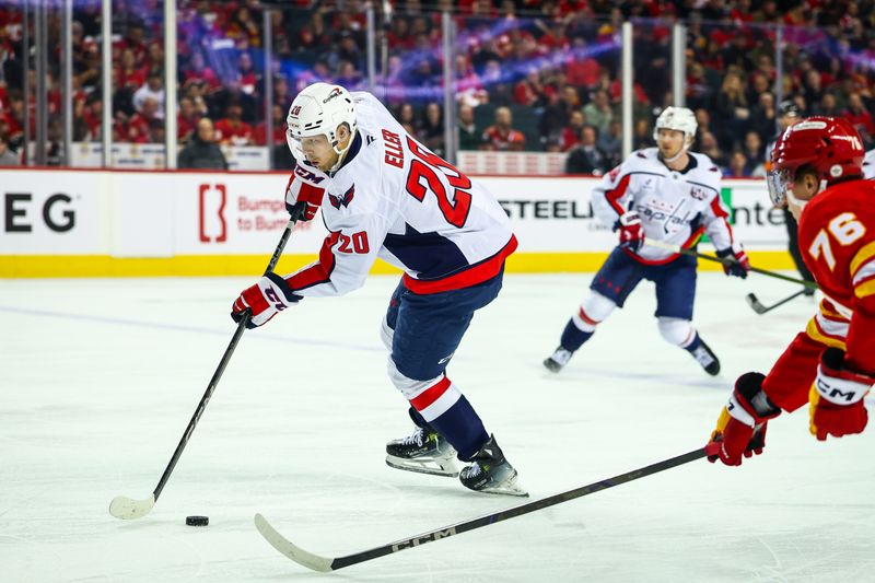 Jan 28, 2025; Calgary, Alberta, CAN; Washington Capitals center Lars Eller (20) controls the puck against the Calgary Flames during the first period at Scotiabank Saddledome. Mandatory Credit: Sergei Belski-Imagn Images