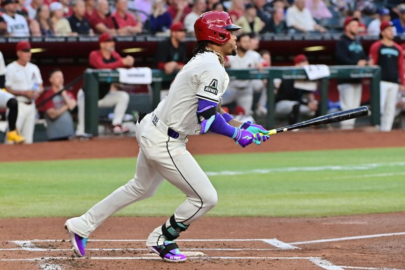 May 1, 2024; Phoenix, Arizona, USA;  Arizona Diamondbacks second base Ketel Marte (4) hits a double in the first inning against the Los Angeles Dodgers at Chase Field. Mandatory Credit: Matt Kartozian-USA TODAY Sports