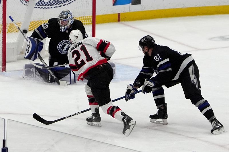 Feb 19, 2024; Tampa, Florida, USA; Ottawa Senators right wing Mathieu Joseph (21) scores against Tampa Bay Lightning goaltender Andrei Vasilevskiy (88) during the first period at Amalie Arena. Mandatory Credit: Dave Nelson-USA TODAY Sports