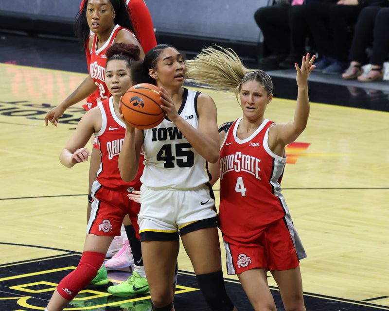 Mar 3, 2024; Iowa City, Iowa, USA; Iowa Hawkeyes forward Hannah Stuelke (45) is defended by Ohio State Buckeyes guard Jacy Sheldon (4) during the first half at Carver-Hawkeye Arena. Mandatory Credit: Reese Strickland-USA TODAY Sports