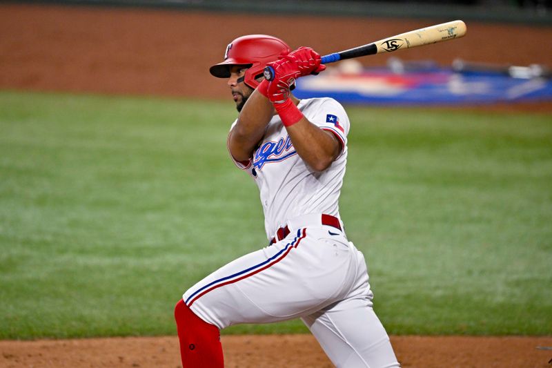 May 16, 2023; Arlington, Texas, USA; Texas Rangers center fielder Leody Taveras (3) hits a single against the Atlanta Braves during the seventh inning at Globe Life Field. Mandatory Credit: Jerome Miron-USA TODAY Sports