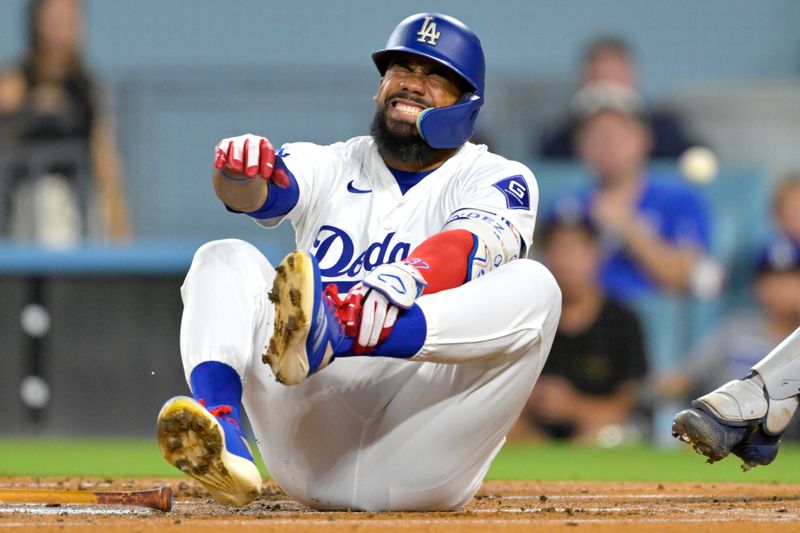 Sep 6, 2024; Los Angeles, California, USA; Los Angeles Dodgers left fielder Teoscar Hernandez (37) reacts as he grabs his left foot as he reacts after being hit by a pitch in the first inning against the Cleveland Guardians at Dodger Stadium. Mandatory Credit: Jayne Kamin-Oncea-Imagn Images