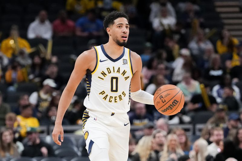 INDIANAPOLIS, INDIANA - OCTOBER 17: Tyrese Haliburton #0 of the Indiana Pacers dribbles the ball in the third quarter against the Charlotte Hornets during a preseason game at Gainbridge Fieldhouse on October 17, 2024 in Indianapolis, Indiana. NOTE TO USER: User expressly acknowledges and agrees that, by downloading and or using this photograph, User is consenting to the terms and conditions of the Getty Images License Agreement. (Photo by Dylan Buell/Getty Images)