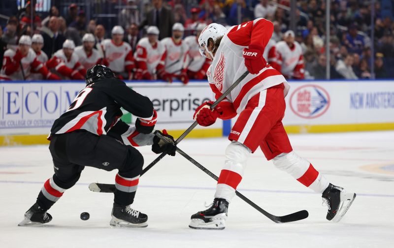 Oct 26, 2024; Buffalo, New York, USA;  Buffalo Sabres center Peyton Krebs (19) blocks a shot by Detroit Red Wings defenseman Moritz Seider (53) during the first period at KeyBank Center. Mandatory Credit: Timothy T. Ludwig-Imagn Images