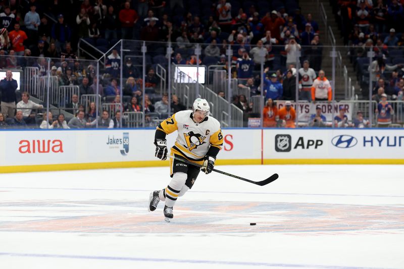 Nov 5, 2024; Elmont, New York, USA; Pittsburgh Penguins center Sidney Crosby (87) plays the puck against the New York Islanders during the shootout at UBS Arena. Mandatory Credit: Brad Penner-Imagn Images