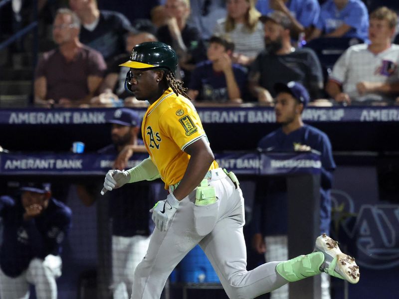 Jun 30, 2025; Tampa, Florida, USA;  Athletics outfielder Lawrence Butler (4) hits a two-RBI triple against the Tampa Bay Rays during the ninth inning at George M. Steinbrenner Field. Mandatory Credit: Kim Klement Neitzel-Imagn Images