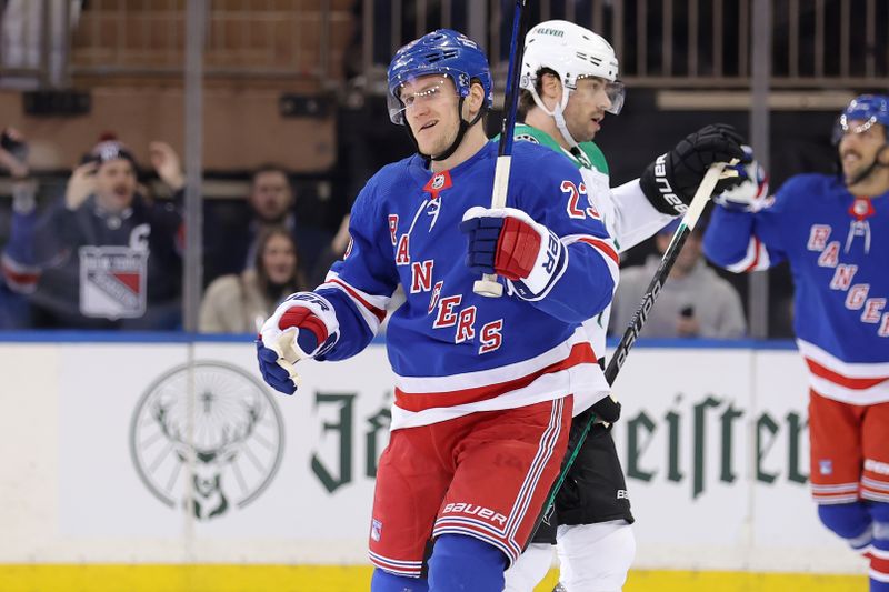 Feb 20, 2024; New York, New York, USA; New York Rangers defenseman Adam Fox (23) celebrates his goal against the Dallas Stars in front of Stars center Craig Smith (15) during the first period at Madison Square Garden. Mandatory Credit: Brad Penner-USA TODAY Sports