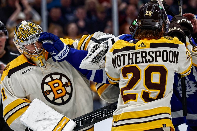 Mar 7, 2024; Boston, Massachusetts, USA; A Toronto Maple Leafs glove comes out of a scrum in front into the face of Boston Bruins goaltender Jeremy Swayman (1) during the second period at TD Garden. Mandatory Credit: Winslow Townson-USA TODAY Sports