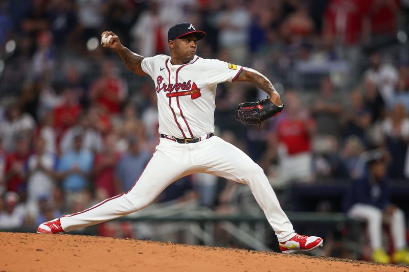 Sep 24, 2024; Atlanta, Georgia, USA; Atlanta Braves relief pitcher Raisel Iglesias (26) throws against the New York Mets in the ninth inning at Truist Park. Mandatory Credit: Brett Davis-Imagn Images
