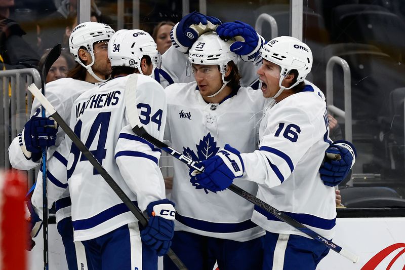 Oct 26, 2024; Boston, Massachusetts, USA; Toronto Maple Leafs left wing Matthew Knies (23) is congratulated by right wing Mitch Marner (16) and center Auston Matthews (34) after his goal against the Boston Bruins during the second period at TD Garden. Mandatory Credit: Winslow Townson-Imagn Images