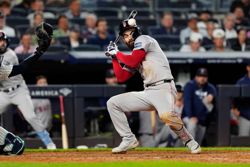 Sep 12, 2024; Bronx, New York, USA; Boston Red Sox first baseman Connor Wong (12) dunks from an inside pictch during the ninth inning against the New York Yankees at Yankee Stadium. Mandatory Credit: Gregory Fisher-Imagn Images