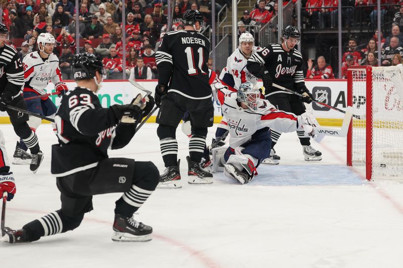 Dec 27, 2025; Newark, New Jersey, USA; New Jersey Devils left wing Jesper Bratt (63) scores a goal on Washington Capitals goaltender Logan Thompson (48) during the second period at Prudential Center. Mandatory Credit: Ed Mulholland-Imagn Images